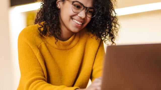 Woman creating her travel policy on her laptop