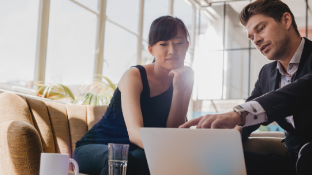 Two people looking at a computer