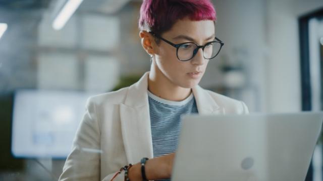 Woman looking at numbers on her laptop