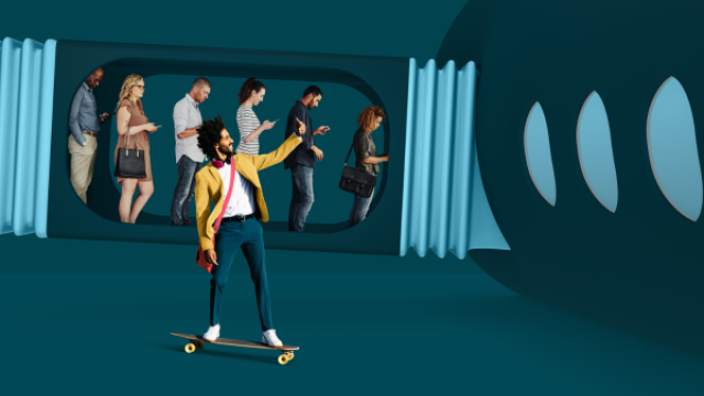 guy on skateboard with cellphone alongside teal boarding gate