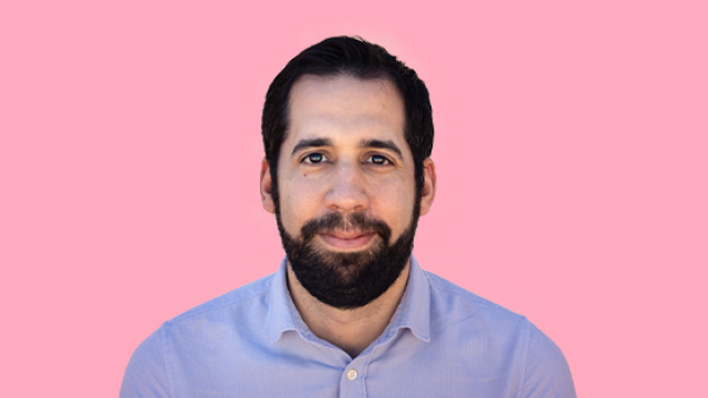Headshot of Adrian Lopez with pink background