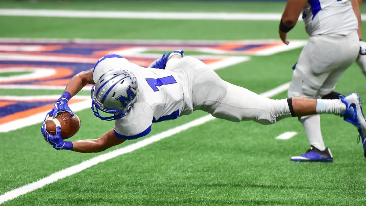 football player catching a football