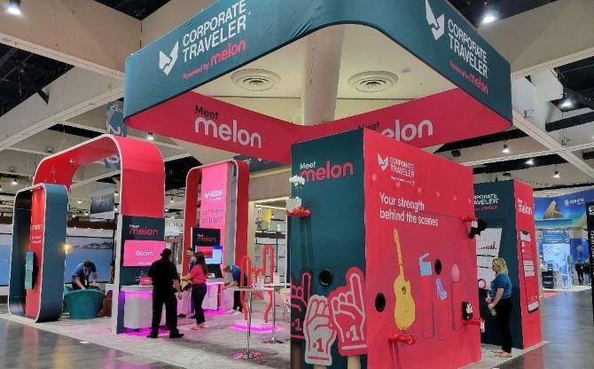 convention booth with bright pink and teal accents