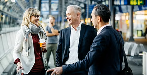 Three people in discussion at the airport representing the importance of a SME business toolkit.