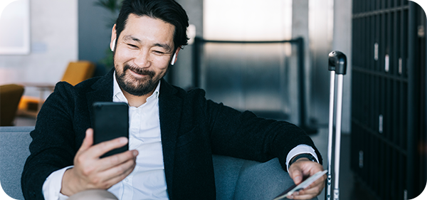 Man sitting on lounge looking at phone.