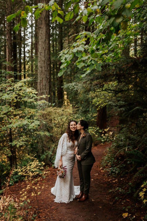 couple standing in the forest on their wedding day