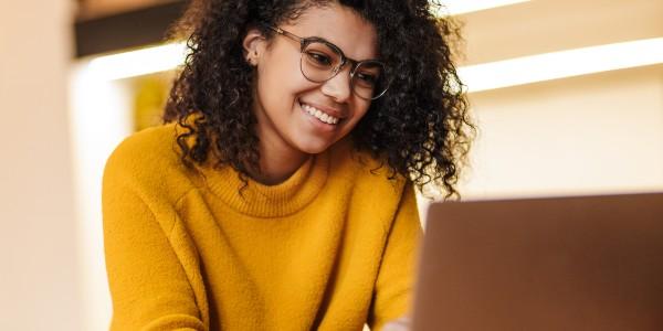 Woman creating her travel policy on her laptop