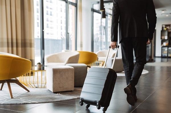 man-in-hotel-with-suitcase.jpg