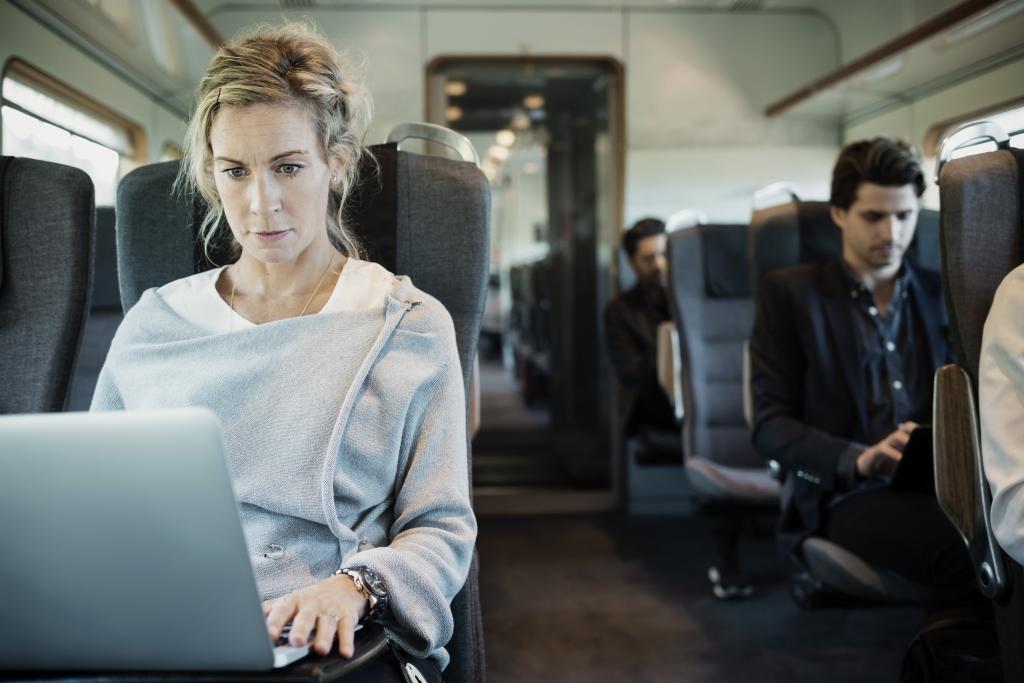 a woman on her laptop on a train