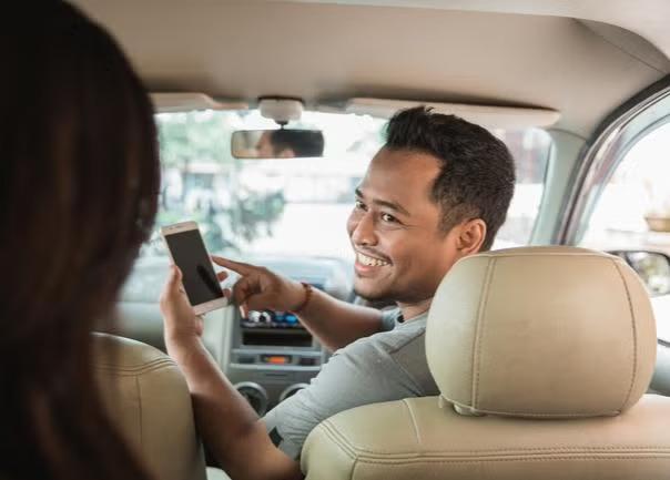 Uber driving talking to a passenger. 