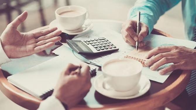 Office table with documents representing essential planning tips for business travel.