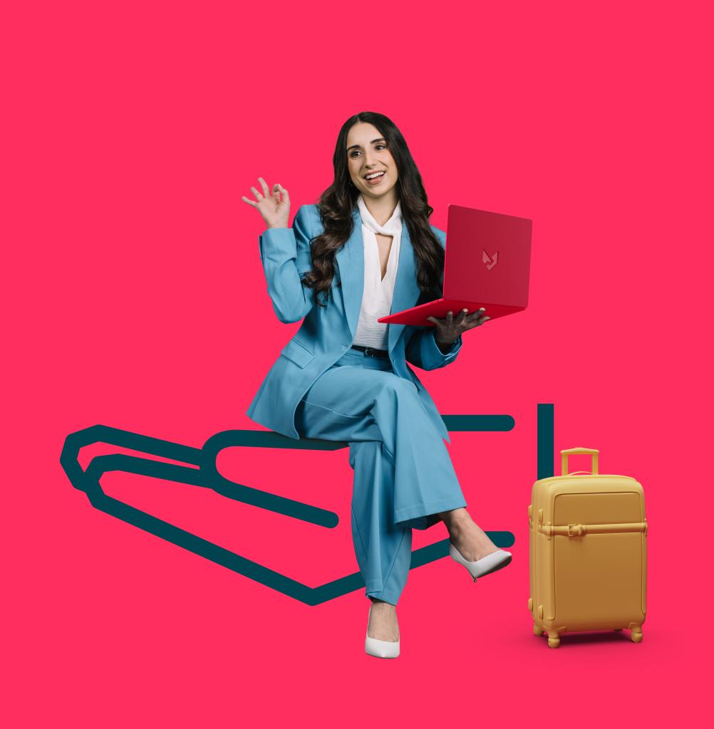 a person holding a laptop with a suitcase beside her