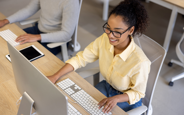Woman sitting at computer smiling