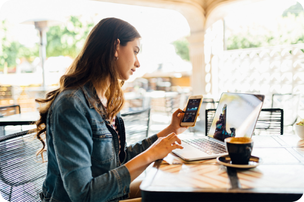 woman sitting at a desk looking at her phone