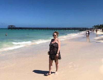 woman is summer dress standing on beach in turks and caicos