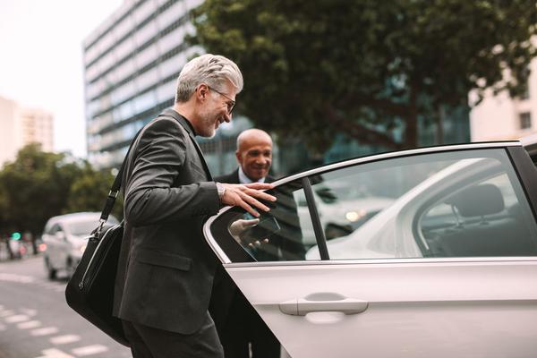 businessman getting in to car transfer