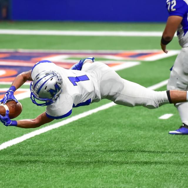 football player catching a football